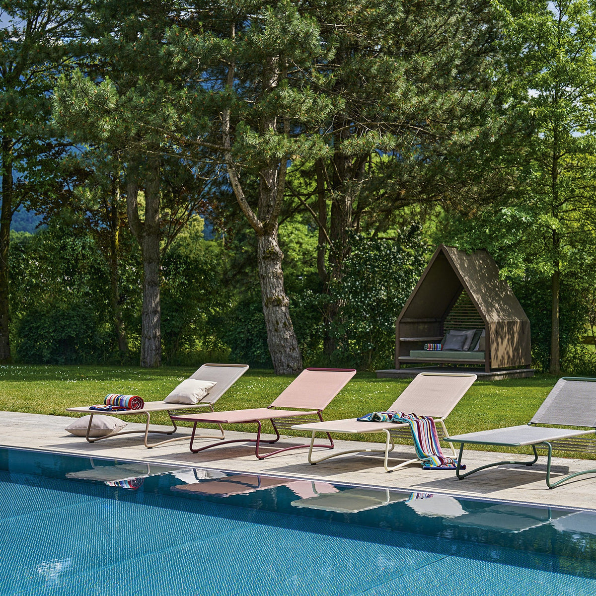 Vier Weishäupl Balcony Sonnenliegen in Marone, Koralle, Creme und Salbei am Pool